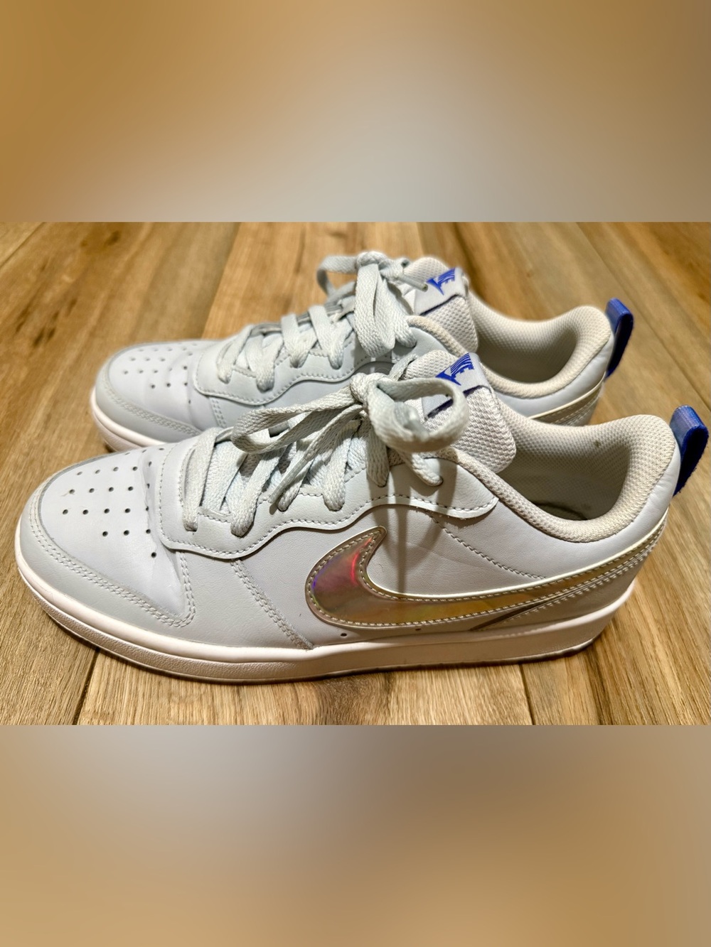 Nike Kids White Sneakers with Iridescent Swoosh and Blue Accents